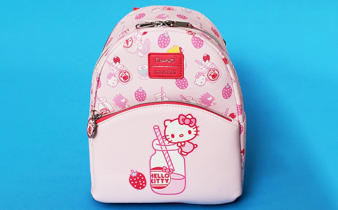 Loungefly Hello Kitty Strawberry Milk Backpack on Blue Surface