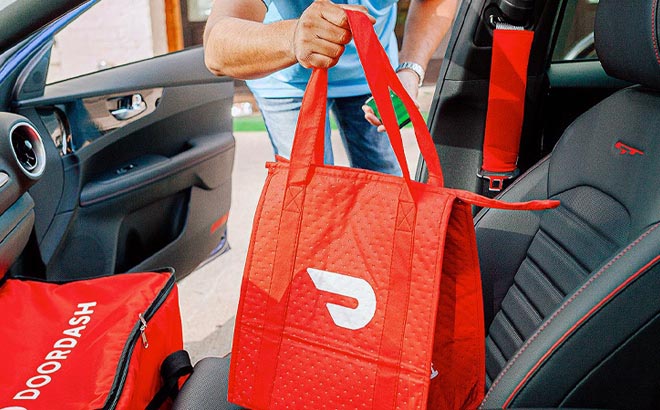 Man holding DoorDash Bag and exiting a car