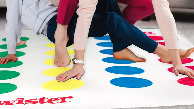 Mother and Son Playing on Hasbro Twister Game Blanket