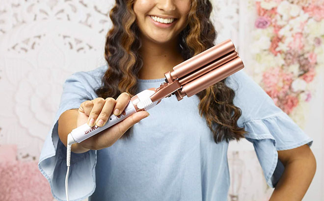 Person Holding a Ceramic Conair Three Barrel Hair Styler