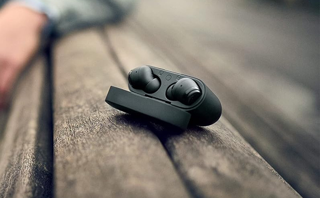 Philips T2206 True Wireless Earbuds with IPX4 Water Resistance and Super Small Charging case on a Wooden Table