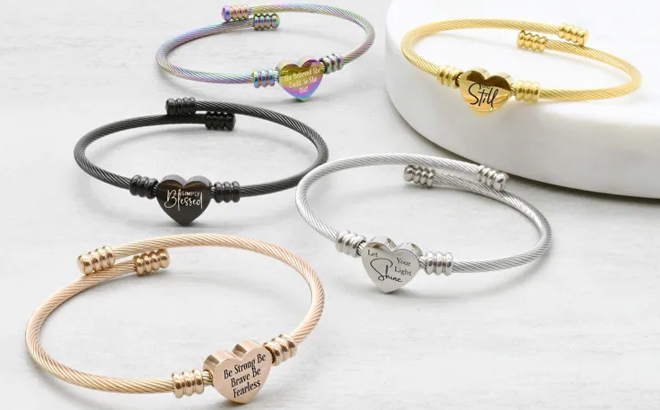 Several Reversible Inspirational Heart Bracelets on a Table