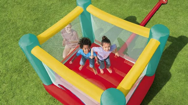 Two Kids Playing on Play Day Jump and Soar Inflatable Bouncer