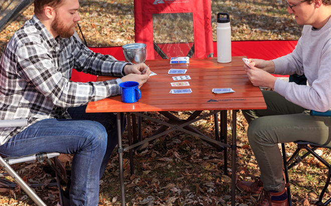 Two Men Playing Cards on the Ozark Trail Square Folding Aluminum Roll Top Camp Table