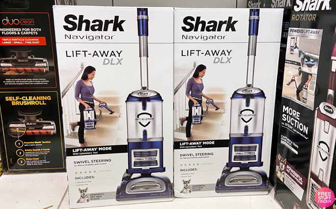 Two Shark Navigator Lift Away Deluxe Upright Vacuums on a Shelf