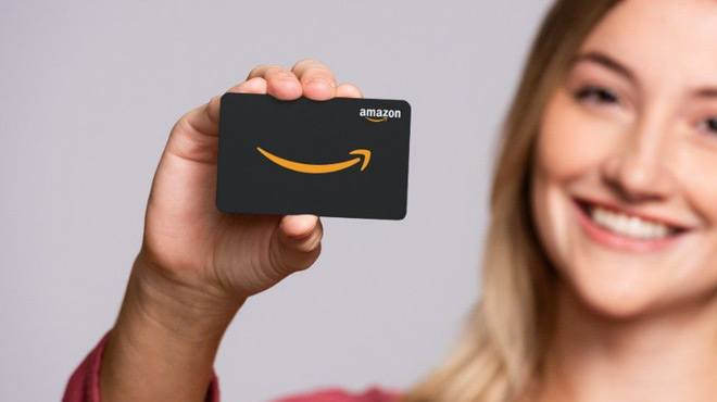 Woman Holding an Amazon Giftcard