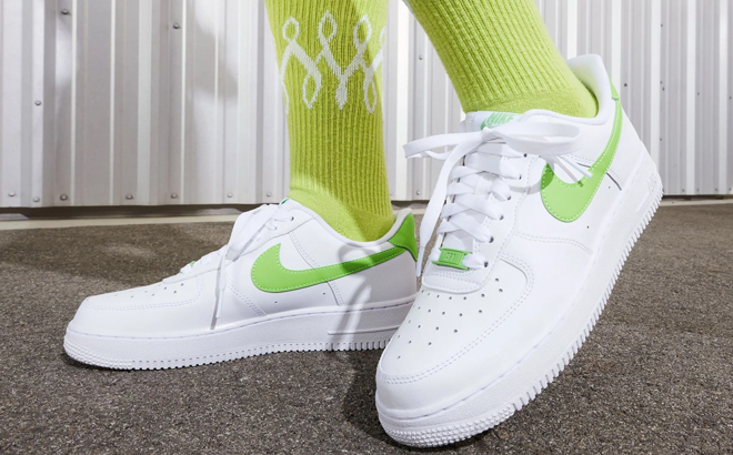 Woman Wearing Nike Air Force 1 07 Shoes in Action Green Color