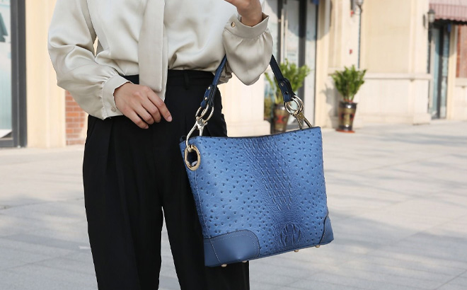 Woman is Holding MKF Collection Wandy Soft Vegan Leather Hobo and Wallet Set in Blue Color