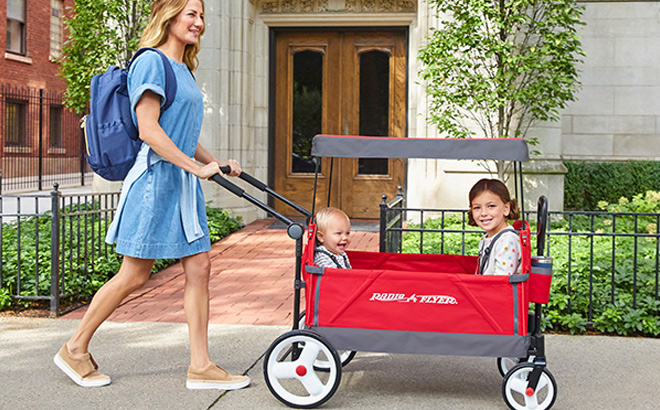 Woman is Pulling Radio Flyer Convertible Stroller Wagon with Canopy