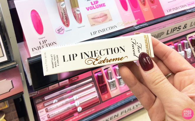 a Hand Holding Too Faced Lip Injection Lip Plumper