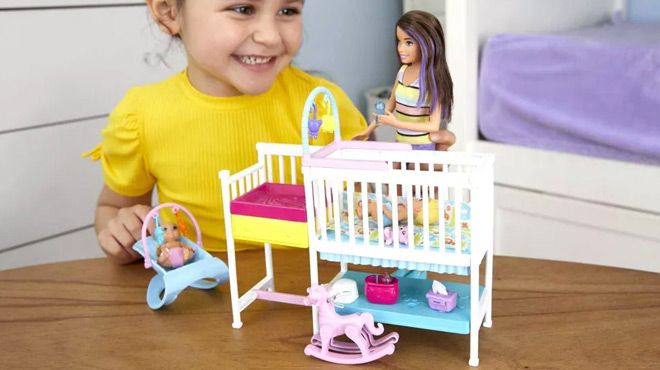 A Child Playing with Barbie Skipper Babysitters Nursery Dolls and Playset