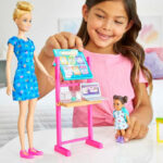 A Child Playing with the Barbie Teacher Doll Set