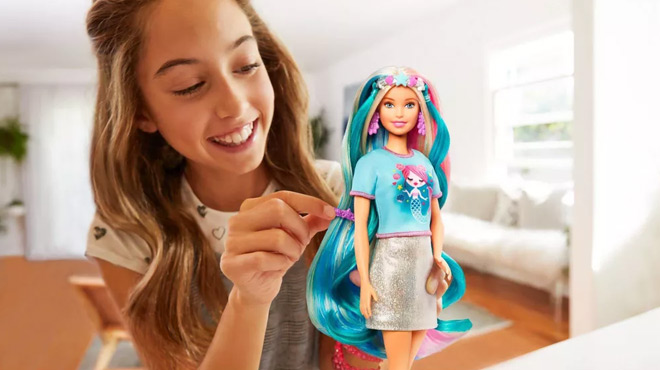 A Girl Playing with Barbie Fantasy Hair Doll