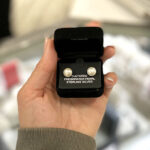 A Hand Holding a Belle De Mer Button Pearl Stud Earrings