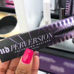 A Hand Holding a Urban Decay Perversion Volumizing Mascara