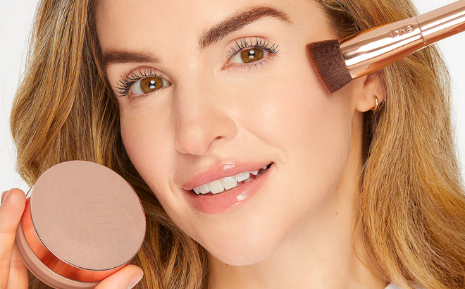 A Person Using Tarte Foundation and Brush Set