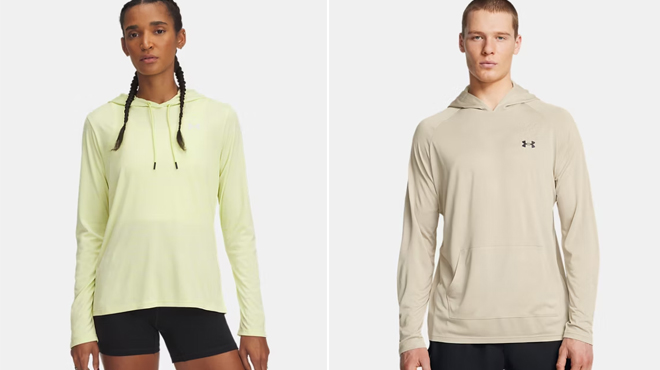 A lady wearing a Under Armour Womens UA Tech Hoodie on the left and a man wearing Under Armour Mens Velocity Jacquard Hoodie on the right