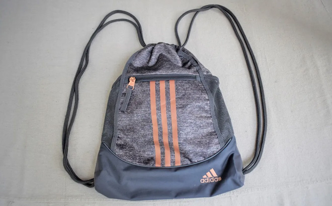 Adidas Alliance Drawstring Sackpack in Jersey Onix Rose Gold on the Bed