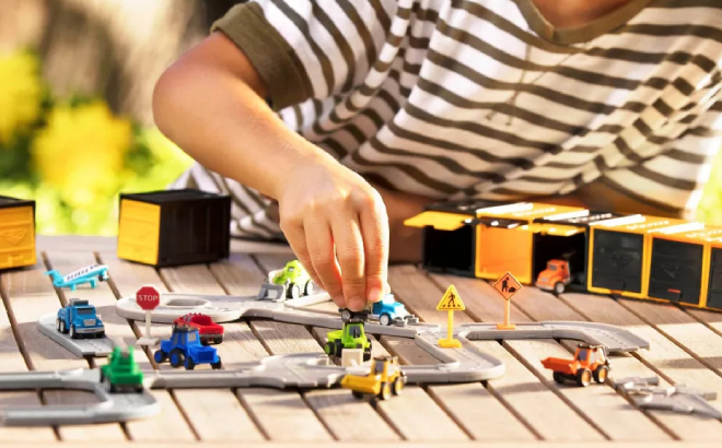 Boy Playing with Driven Mini Toy Vehicles