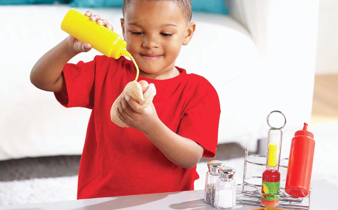 Boy Playing with Melissa Doug 6 Piece Condiment Set