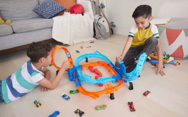 Boys Playing with Hot Wheels Ultra Hots Blast Launch Face Off Track Set