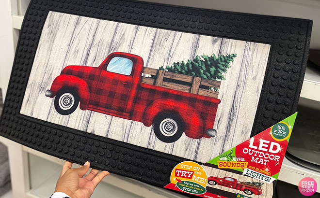 Hand Holding Loomaknoti Winter Truck LED Doormat