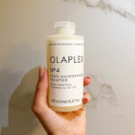 Hand Holding Olaplex Bond Maintenance Shampoo