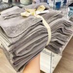 Hand Holding a The Big One 12 piece Bath Towel Set in Gray