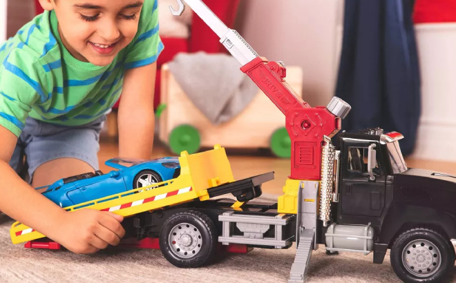 Little Boy Playing with his Driven Tow Truck