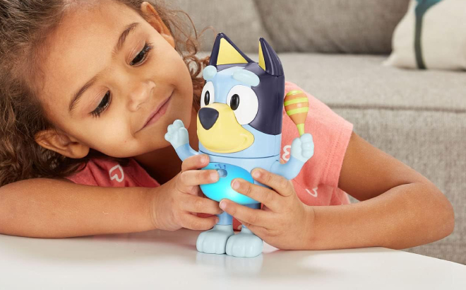 Little Girl Playing with VTech Bluey Shake It Bluey Toy