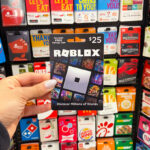 Person Holding Roblox 25 Gift Card