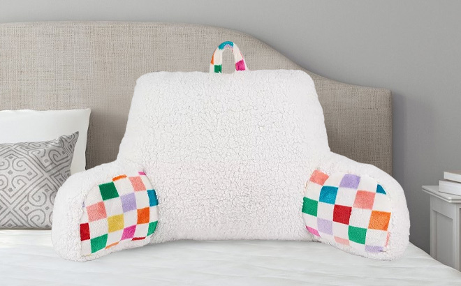 The Big One Multi Color Checker Backrest Pillow on a Bed