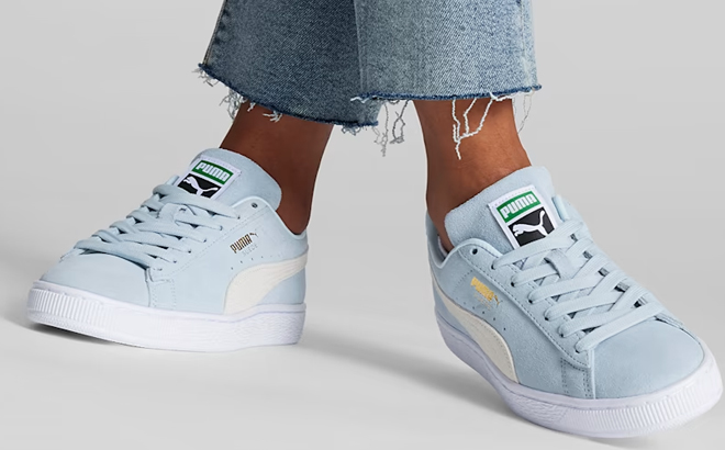 Woman Wearing Puma Suede Classic XXI Sneakers in Icy Blue