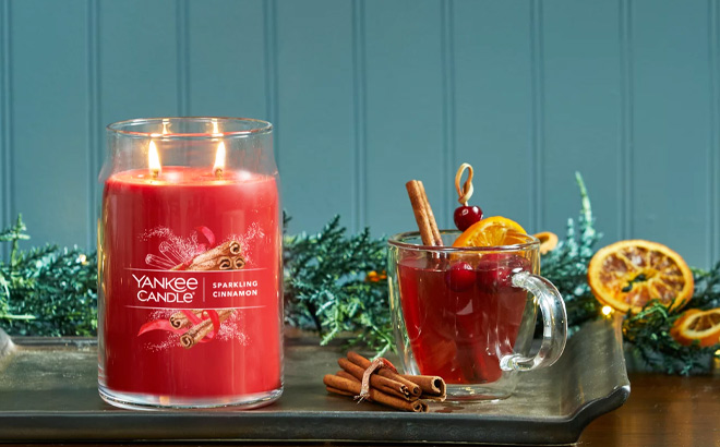 Yankee 2 Wick Candle Sparkling Cinnamon Scented next to a Cinnamon Tea