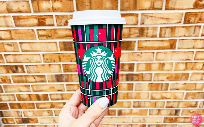 https://www.freestufffinder.com/wp-content/uploads/2023/11/a-Hand-Holding-Starbucks-Holiday-Cup.jpg
