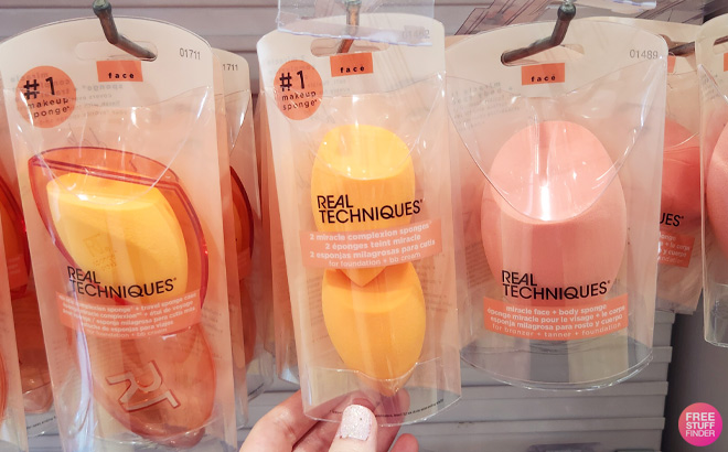 a Hand Touching Real Techniques Miracle Complexion Sponge Duo