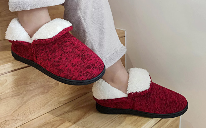 a Woman Wearing Fuzzy Slippers Booties in Red Color