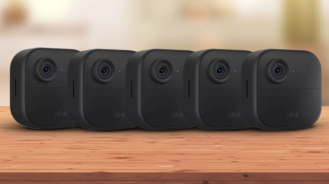 an Image of Blink Outdoor Camera Security System 5 Pack on a Wooden Table