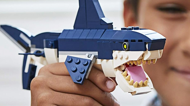 A Boy Holding LEGO Creator 3 in 1 Deep Sea Creatures Shark