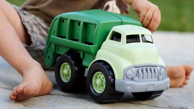 A Child Playing witth Green Toys Recycling Truck