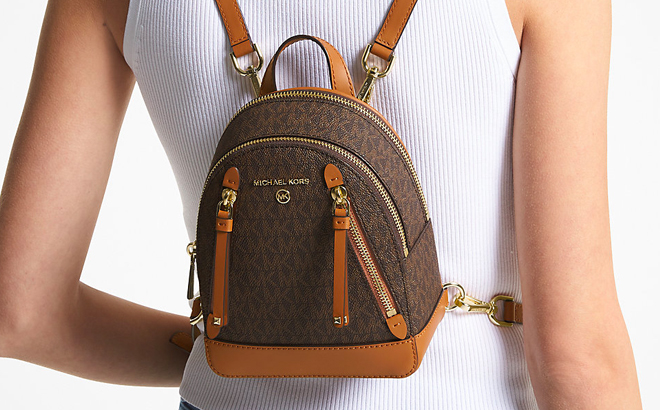 A Person Wearing Brown Michael Kors Mini Brooklyn Backpack