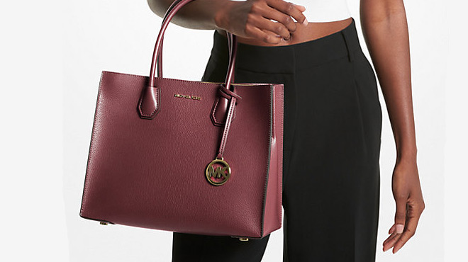 A lady carrying Michael Kors Large Leather Accordion Tote Bag