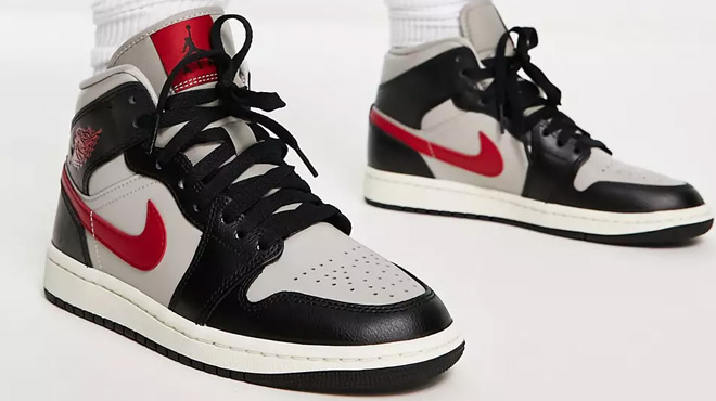 A pair of Air Jordan 1 Mid sneakers black college gray and gym red