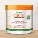 Cantu Leave In Conditioning Repair Cream with Argan Oil on a Wooden Table