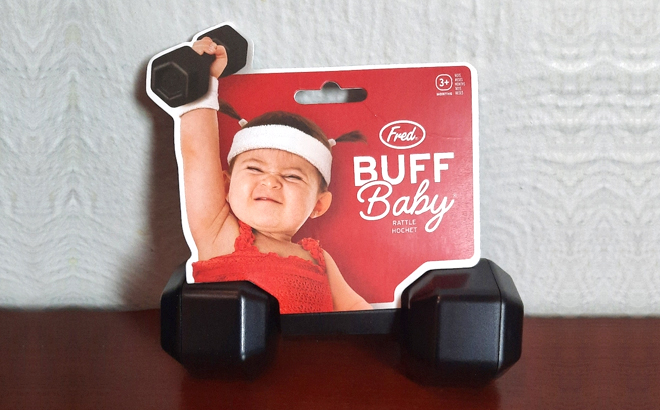 Fred Buff Baby Dumbbell Rattle Toy on a Table