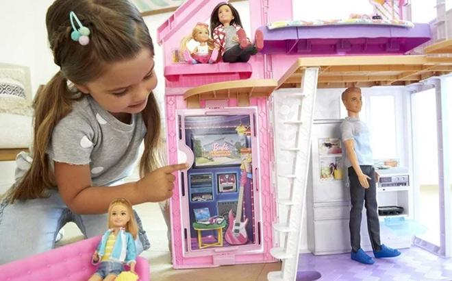 Girl Playing With Barbie Malibu House Playset