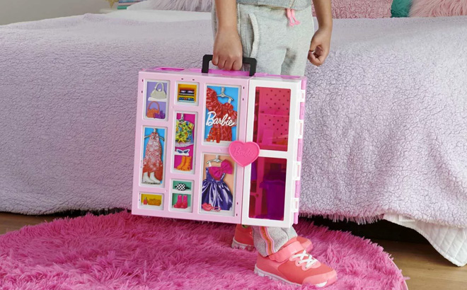 Girl is Holding Barbie Dream Closet Playset