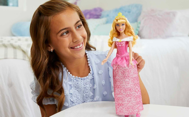 Girl is Holding Mattel Disney Princess Aurora Sleeping Beauty Doll