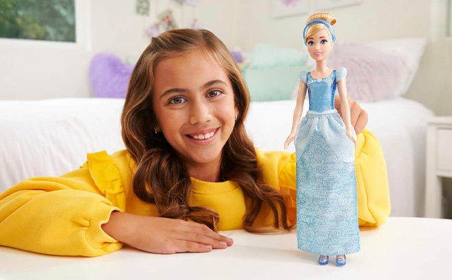 Girl is Holding Mattel Disney Princess Cinderella Doll