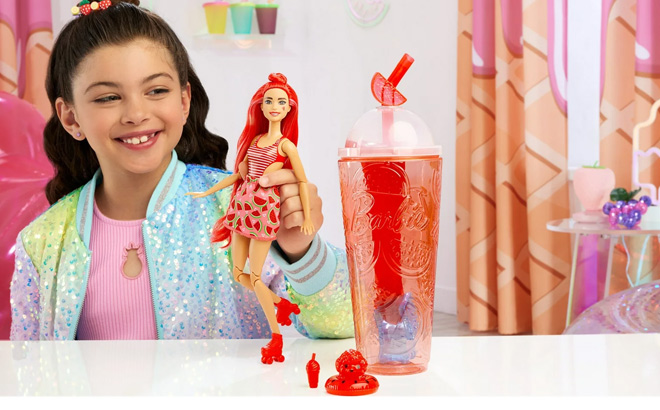 Girl is Playing with Barbie Pop Reveal Fruit Series Watermelon Crush Doll